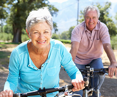 Elderly with health insurance couple riding bikes,