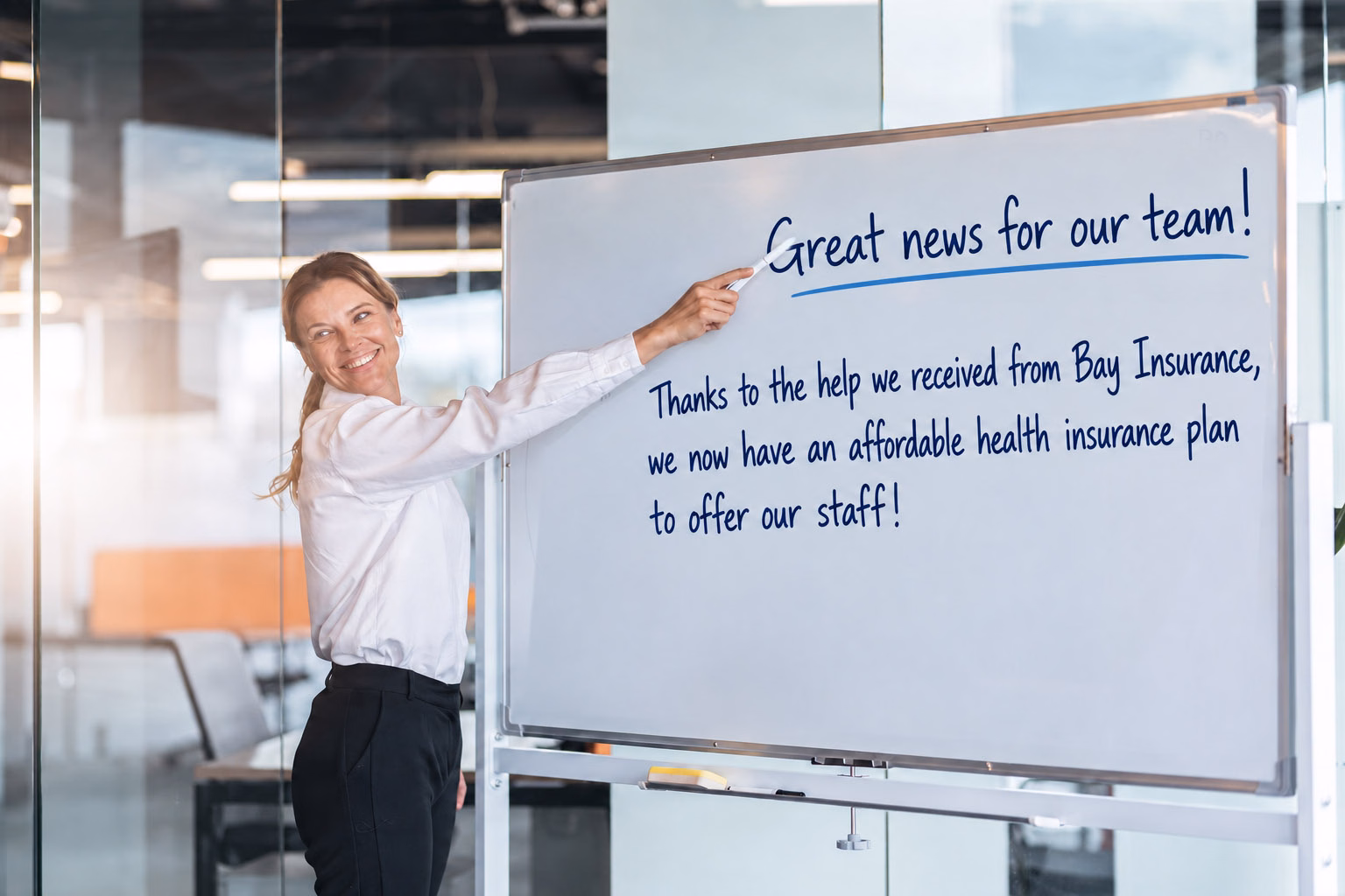 Manager presenting group health insurance benefits on a whiteboard to employees in Lakeland