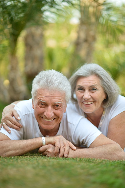 Smiling senior couple outdoors during Medicare open enrollment in Lakeland