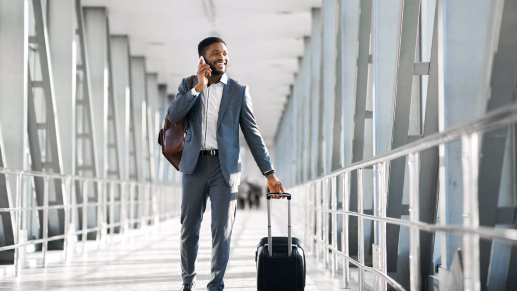 Traveler with luggage in an airport terminal, covered by travel health insurance from Tampa